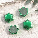 Foil-covered chocolate stars, sage green with round personalized label