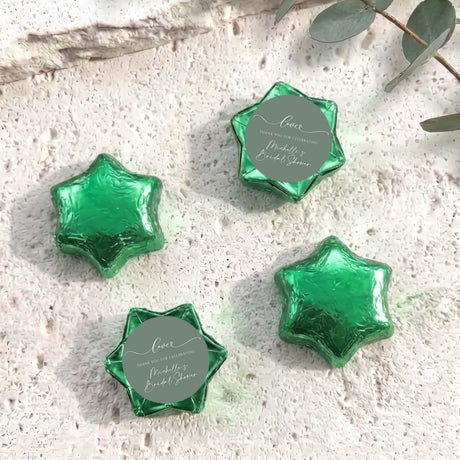 Foil-covered chocolate stars, sage green with round personalized label