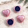 Foil heart chocolates with dark blue label, cross design; purple-pink foil