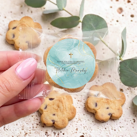 Personalised bite-size choc chip cookie with round blue printed topper and cross
