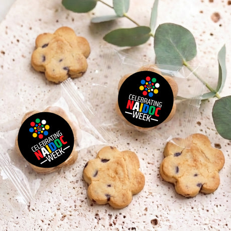 Bite-size choc chip cookies with two black Naidoc Week round stickers