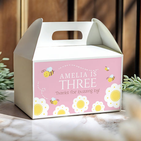 Pink gable favour box with handle cutout, AMELIA IS THREE text, bees