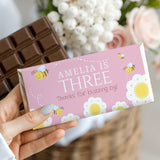 Pink bee-themed birthday chocolate bar wrapper with Amelia’s Three text and bee graphics
