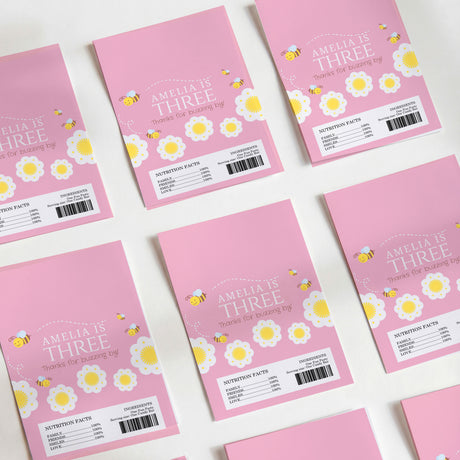 Pink chocolate wrappers, bee and flower print with Amelia's Three text