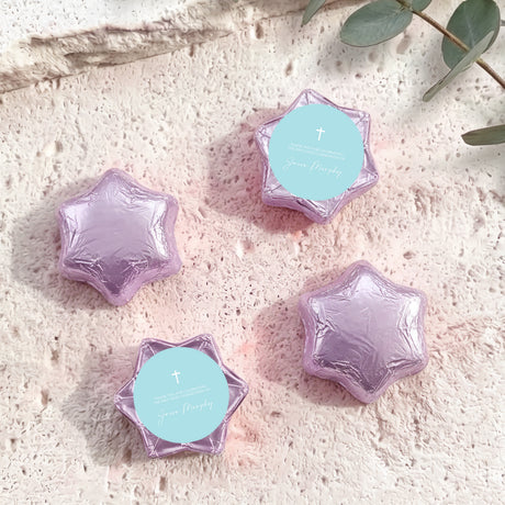 Purple foil-covered chocolate stars with cross medallion labels