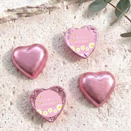 Pink foil heart chocolates with personalised baby-bee shower label on two hearts