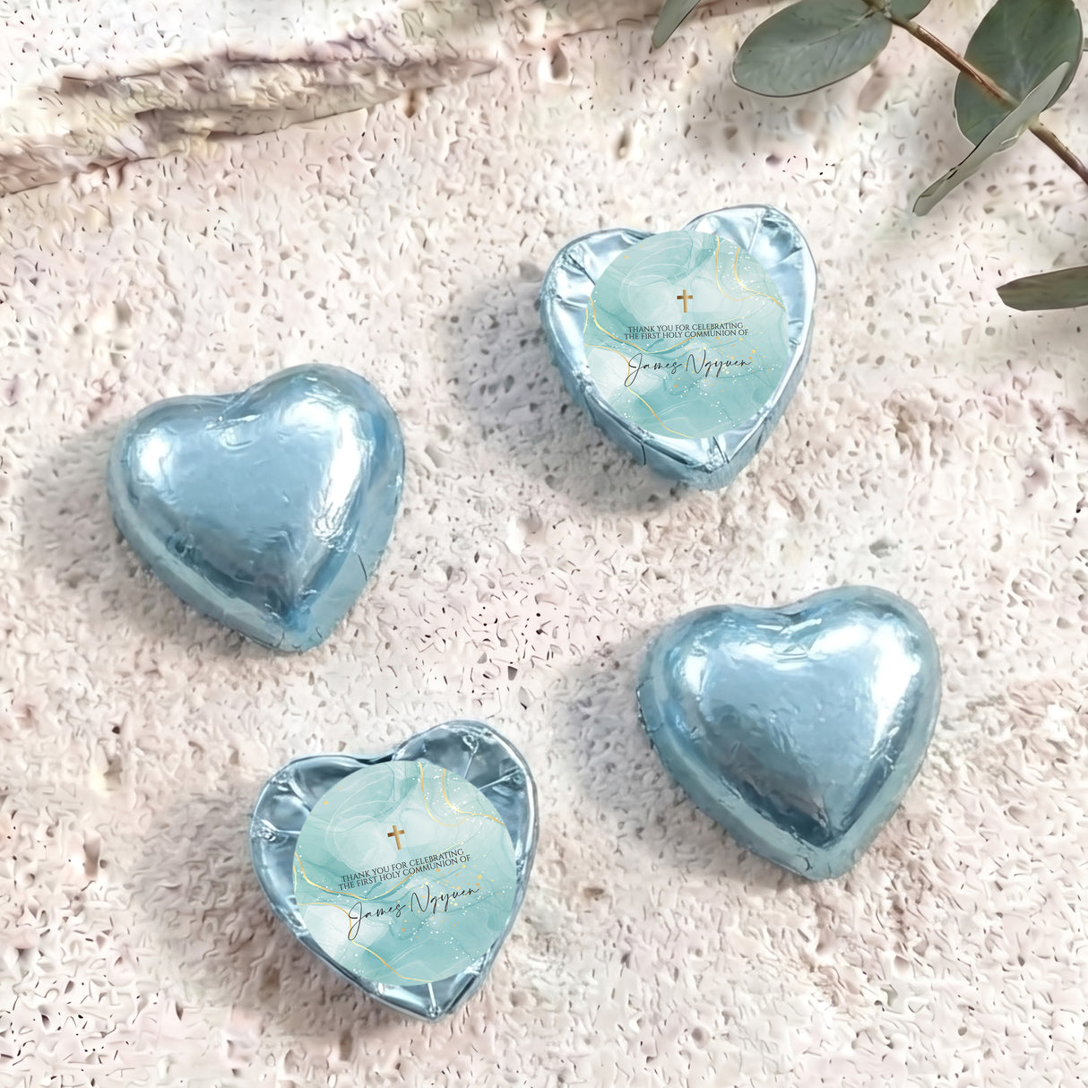 Light blue foil heart chocolates with gold-cross blue center label
