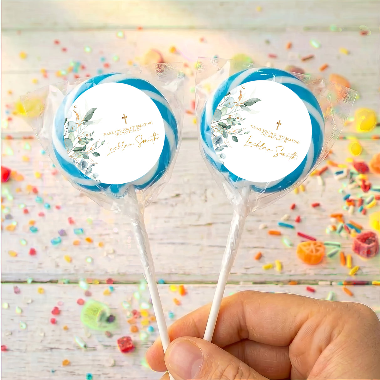 Personalised baptism lollipops: two blue-edged white labels, floral cross design