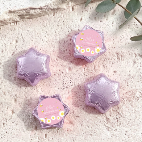 Lilac foil-covered chocolate star with “Dolly’s First Birthday” pink bee label