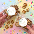 Personalised pretzel bag in clear wrap with brown pretzels and round green-leaf label