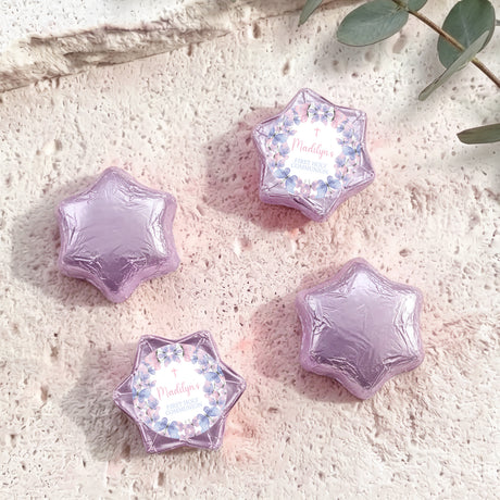 Purple foil-covered chocolate stars with floral First Holy Communion label