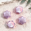 Pink and purple foil-covered chocolate stars with personalized round label