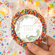 Personalised dinosaur “One” cake topper, SEBASTION ONE text, multicolor sprinkle border