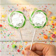Personalised first birthday dinosaur lollipop with green ring, clear wrapper, two on sticks