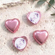 Foil-covered chocolate hearts with pink and purple finishes, floral cross message medallions