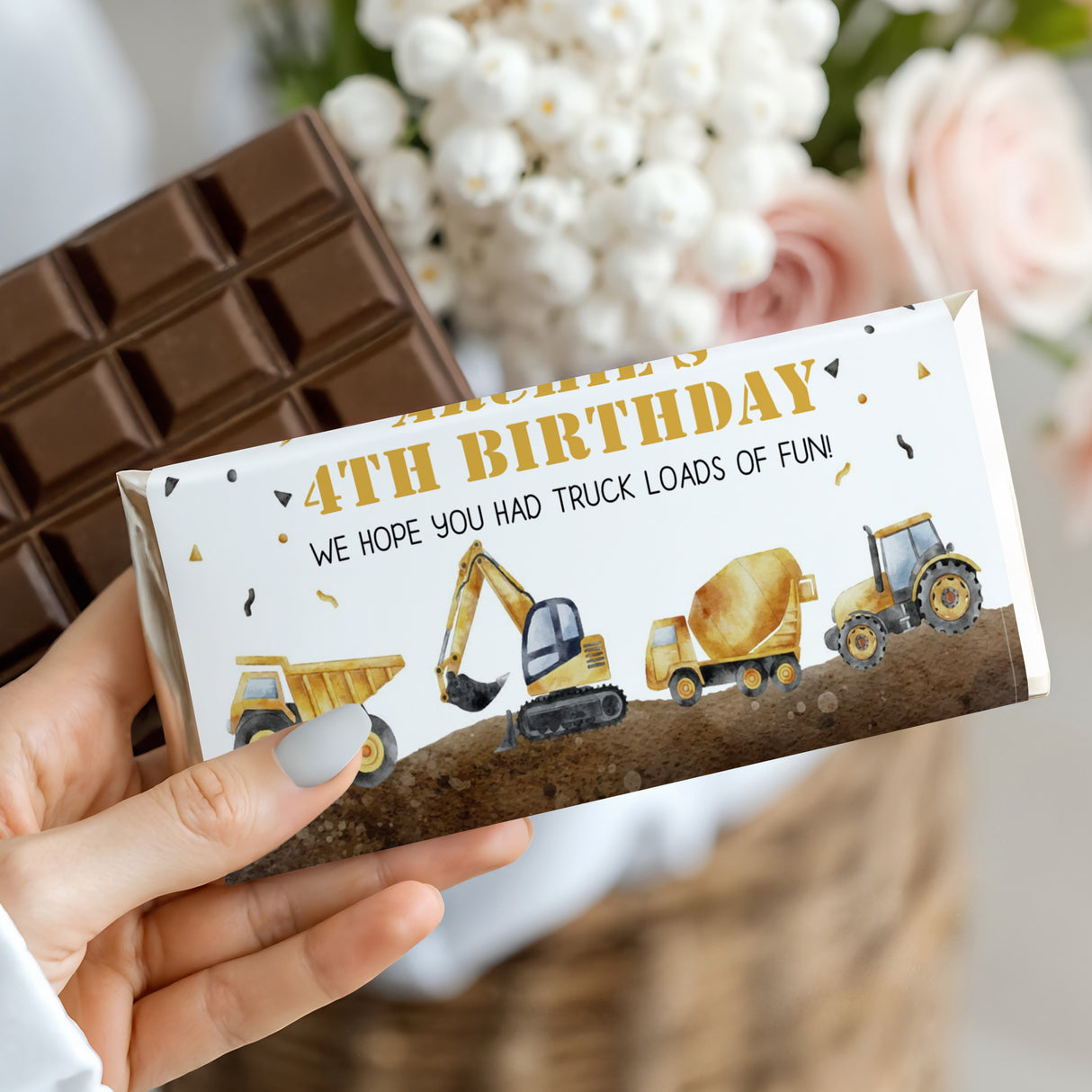 Birthday chocolate bar wrapper with construction vehicles and '4th BIRTHDAY' text