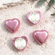 Pink foil-covered confirmation chocolate hearts, one heart shows floral message label