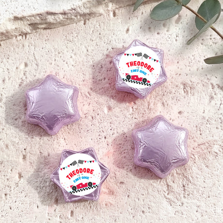 Lilac foil-covered chocolate star sweets with personalized "THEODORE" label
