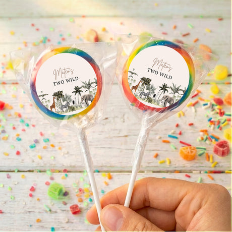 Personalized lollipops with jungle labels and rainbow rims, held in hand