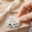 Round jungle safari printed label with animals and text 'A WILD ONE'