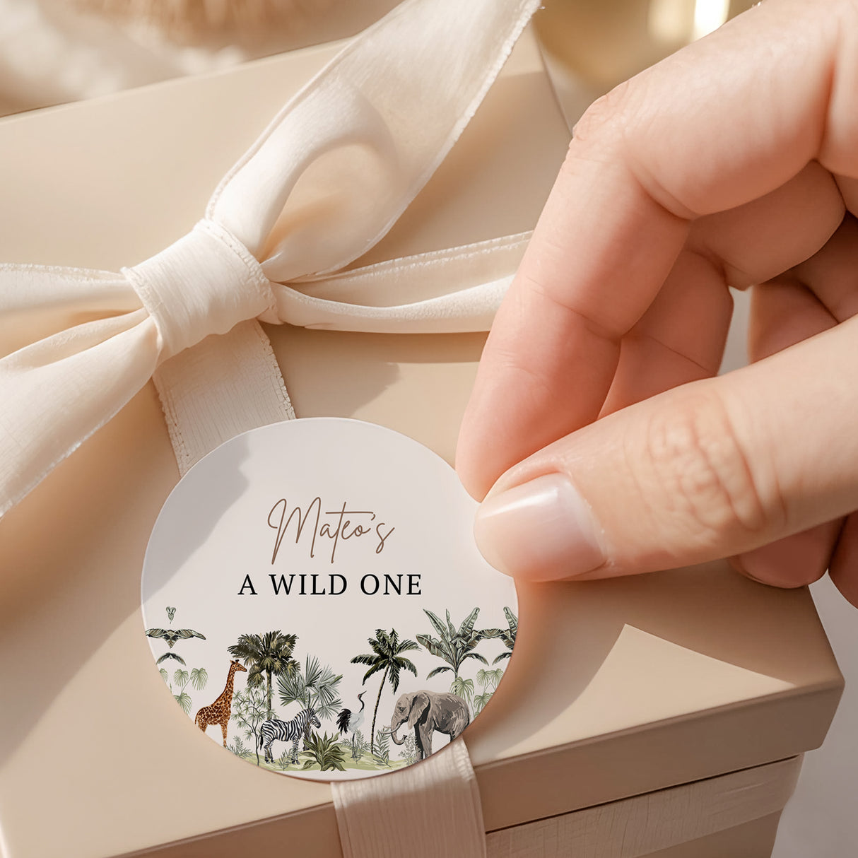 Round jungle safari printed label with animals and text 'A WILD ONE'