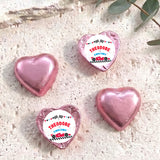 Pink foil-covered chocolate heart with “THEODORE TWO FAST” label