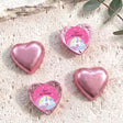 Pink foil chocolate hearts with unicorn label reading “Zara’s 6th Birthday”.