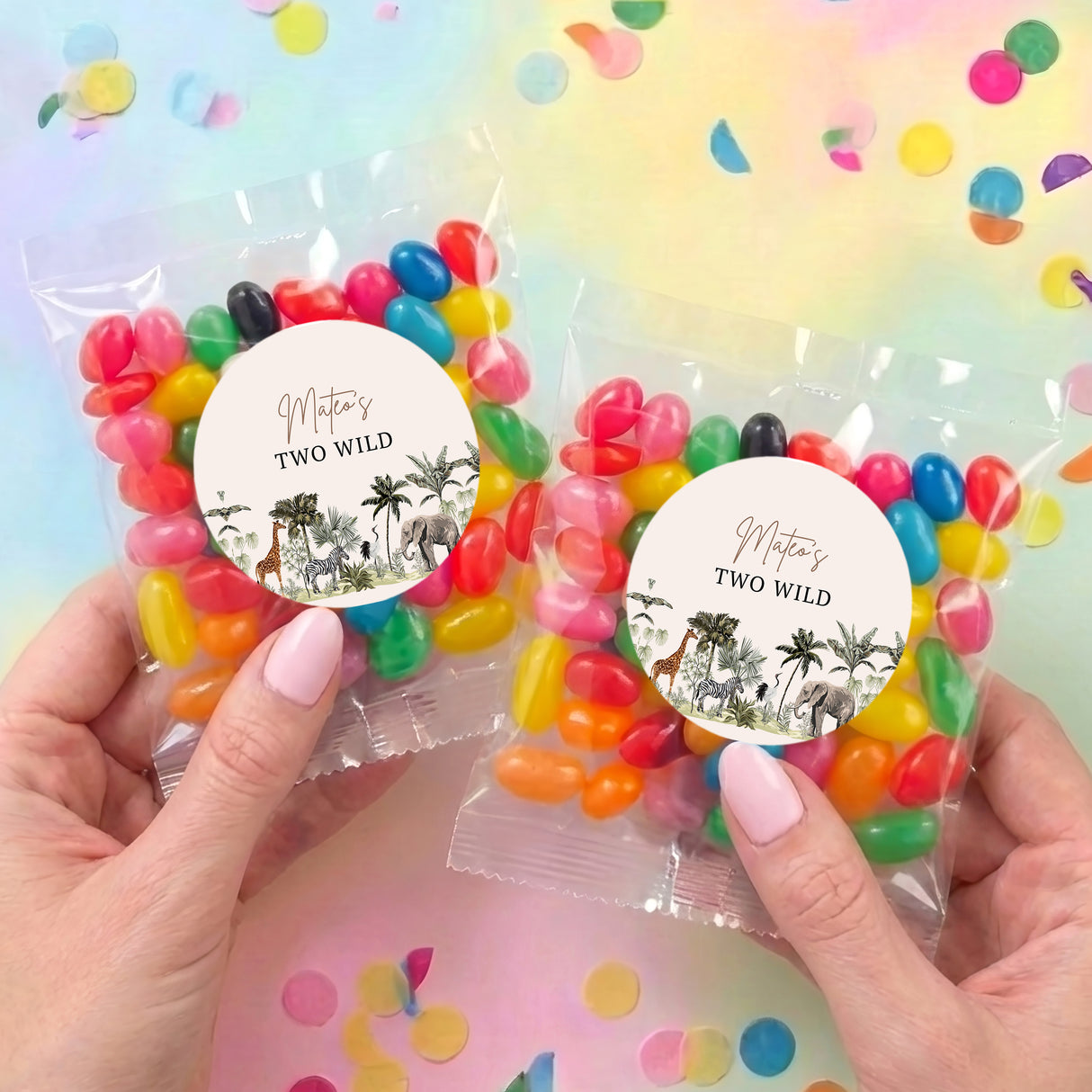 Two jelly bean gift bags with colorful candies and round 'TWO WILD' jungle labels