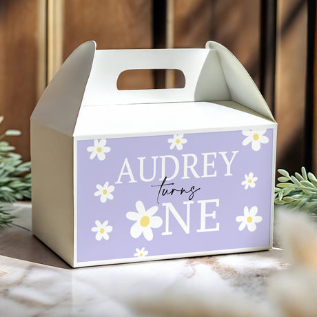 Personalised gable favour box in purple with white daisies, cut-out handle, Audrey turns One.