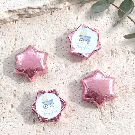 Pink foil star chocolates with baby-themed label card attached