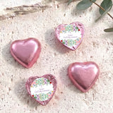 Pink foil-covered chocolate hearts, three hearts with personalised First Holy Communion label