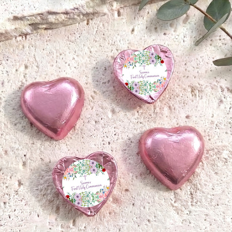 Pink foil-covered chocolate hearts, three hearts with personalised First Holy Communion label