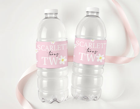 Personalised drink bottle labels on two clear plastic bottles with pink daisy design