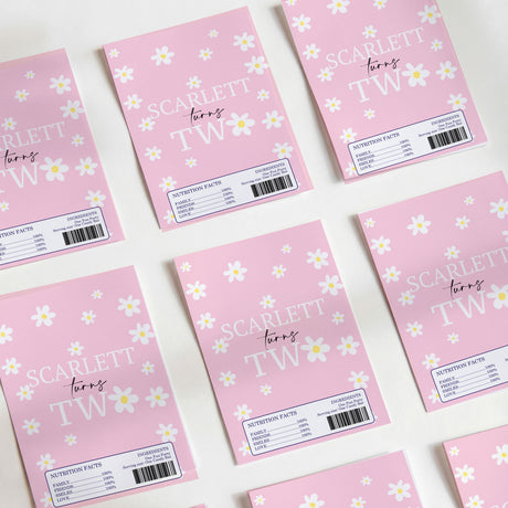 Pink DIY chocolate wrappers with daisy print and SCARLET TW text, barcode labels.