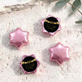 60th birthday star chocolates with pink foil-covered stars and black-and-gold 60 label
