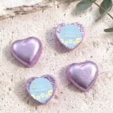 Purple foil-covered chocolate heart with birthday label, heart-shaped foil.