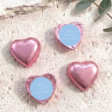 Pink foil heart chocolate favors with round blue personalised label