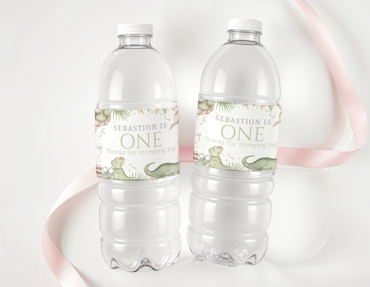 Personalised dinosaur first birthday water bottle labels with “ONE” on clear bottles