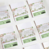 Dinosaur first birthday chocolate wrappers, green nutrition panel and “One” text