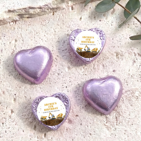 Foil-covered chocolate hearts in lilac with birthday label featuring a construction truck