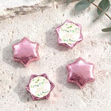 Foil-covered chocolate stars in pink-purple with a printed floral label on one star.