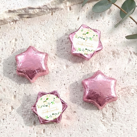Foil-covered chocolate stars in pale pink with floral confirmation label