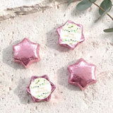 Pink foil-covered chocolate stars with a round personalized label on each piece