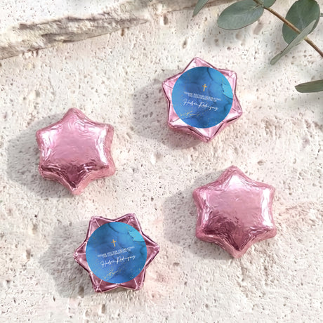 Pink and blue foil-wrapped chocolate star candies with blue personalized center card