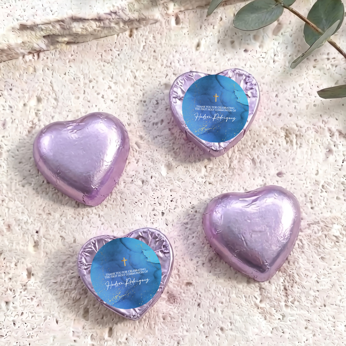 Foil-covered chocolate hearts with purple wrappers and gold cross design