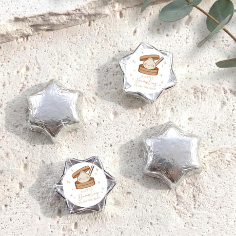 Foil-covered chocolate stars in silver, with a small personalized label circle