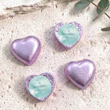 Purple foil heart chocolates with blue center label and gold cross