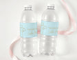 Two clear plastic drink bottles with light blue personalised labels and dove-cross design