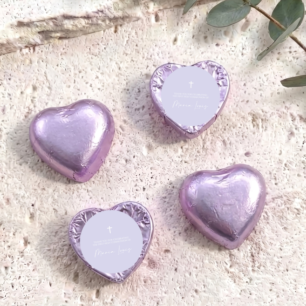 Lilac foil-covered chocolate heart with white center card, cross and name text