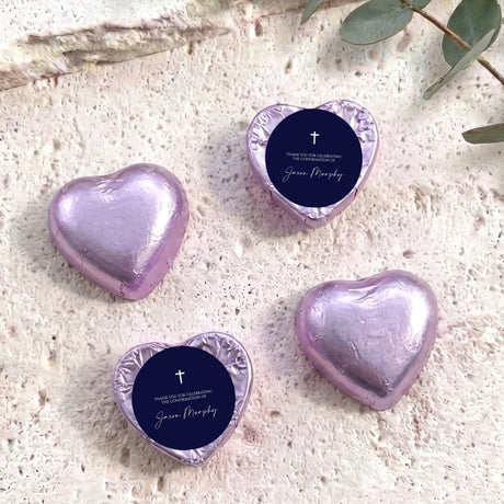Foil heart chocolates with dark blue label and cross; light purple foil hearts